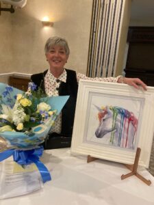 Giving of the art event lady with painting and flowers