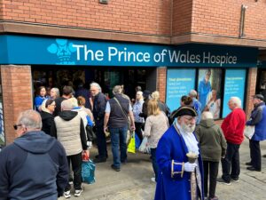 The new The Prince of Wales Hospice superstore town crier and crowd