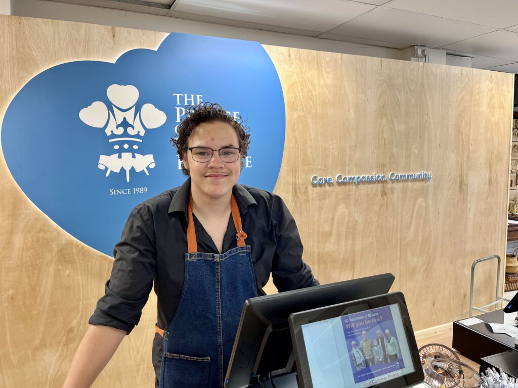 Ethan retail volunteer behind the counter at the Pontefract superstore