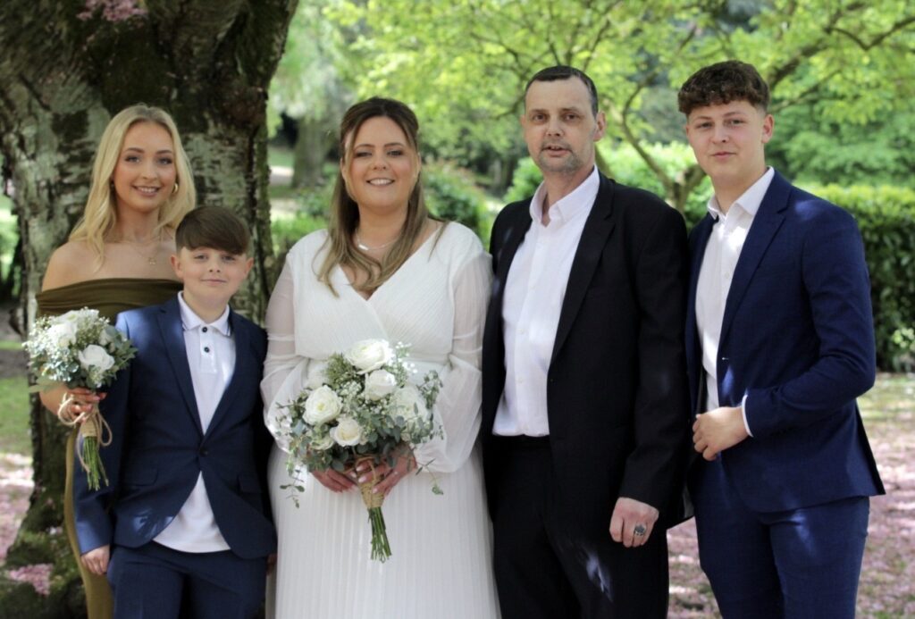 Lindsey and Mick at their wedding with their kids