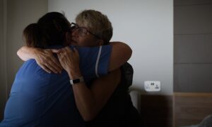 Patient and nurse are hugging