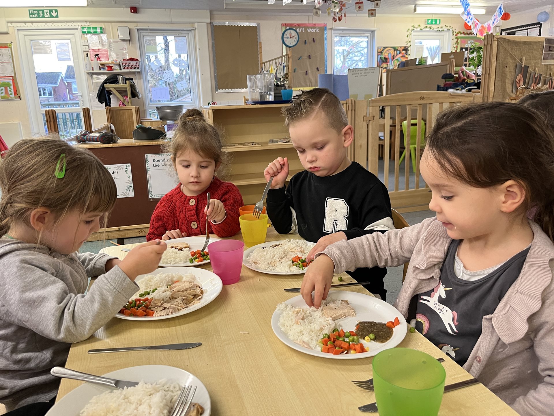 Children eating food at table