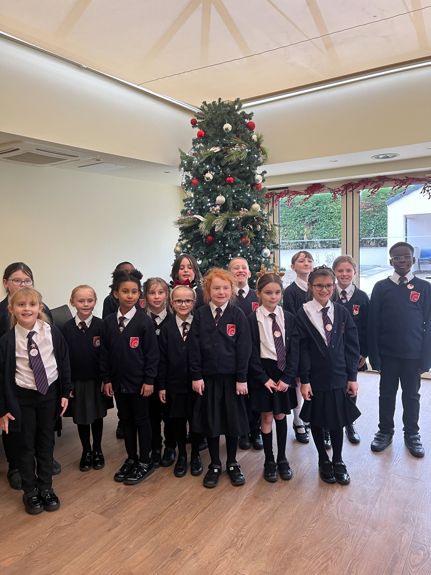 Halfpenny lane school choir in front of the Christmas tree