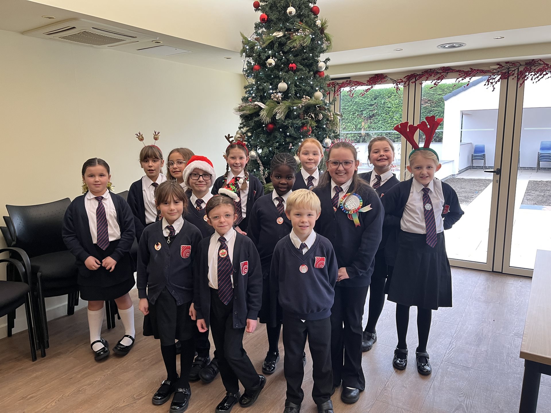 Halfpenny lane school choir in front of the Christmas tree