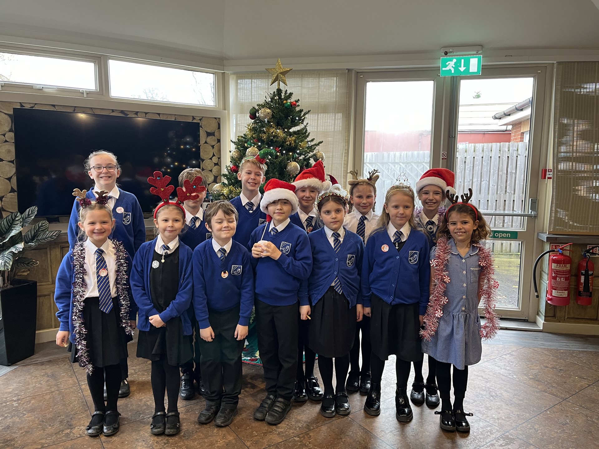 Larks Hill school choir in front of the Christmas tree