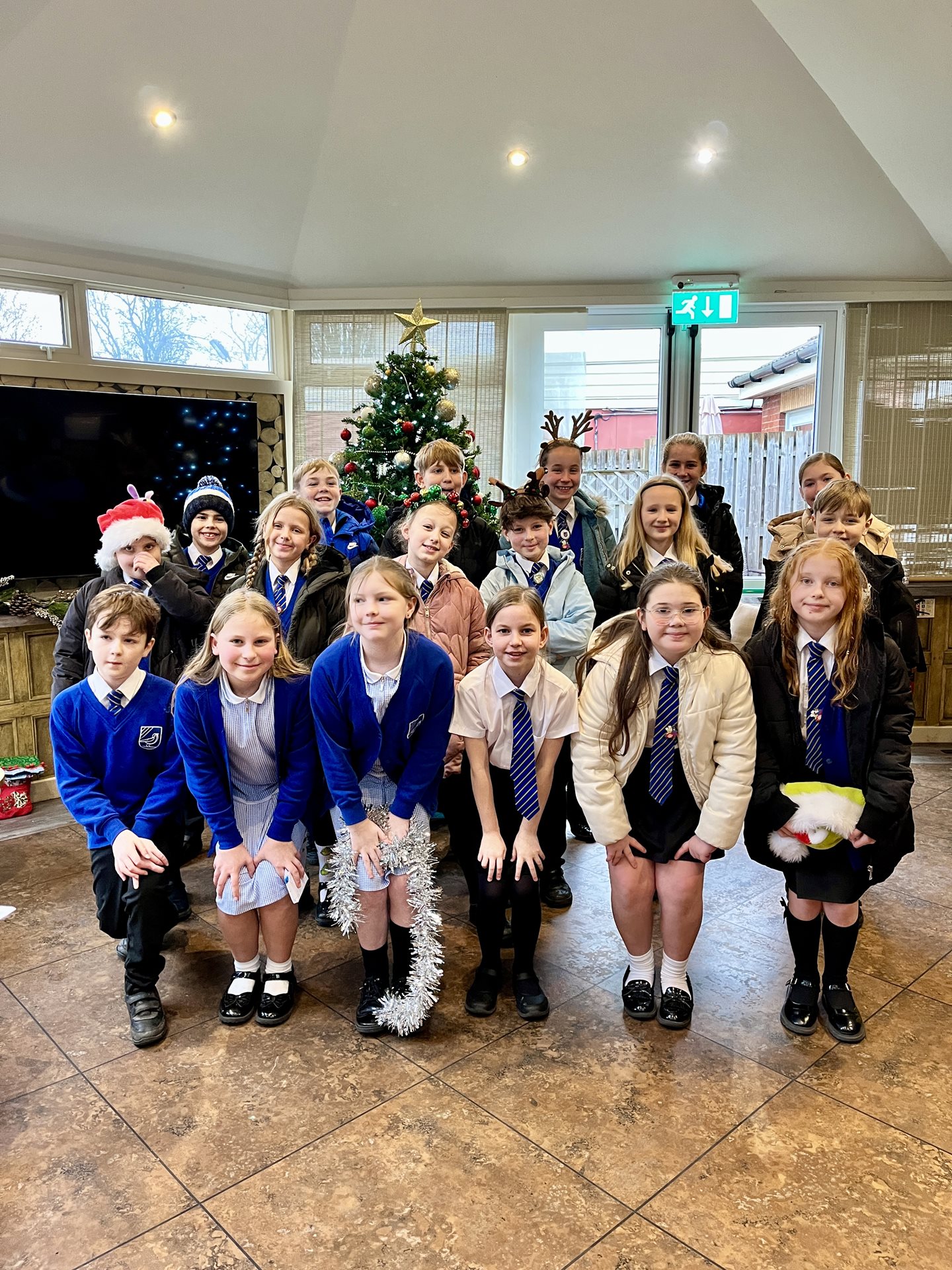 Larks Hill school choir in front of the Christmas tree